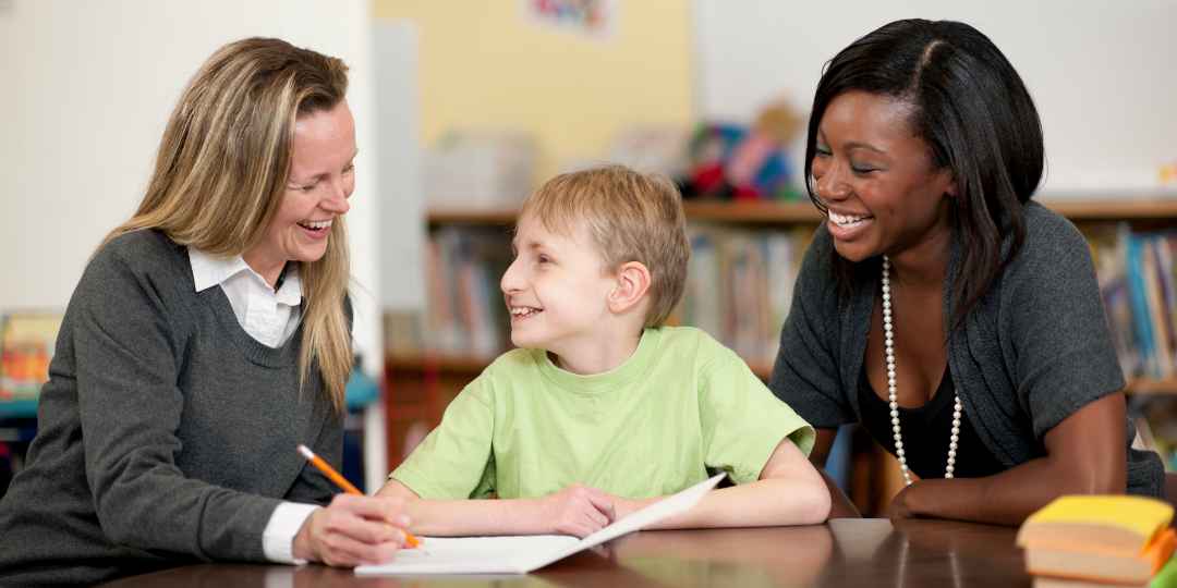 Parent and teacher work with a student in school
